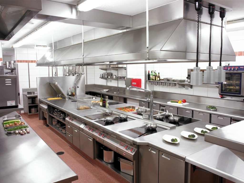 stylish silver interior of commercial Kitchen with vegetables and cutlery